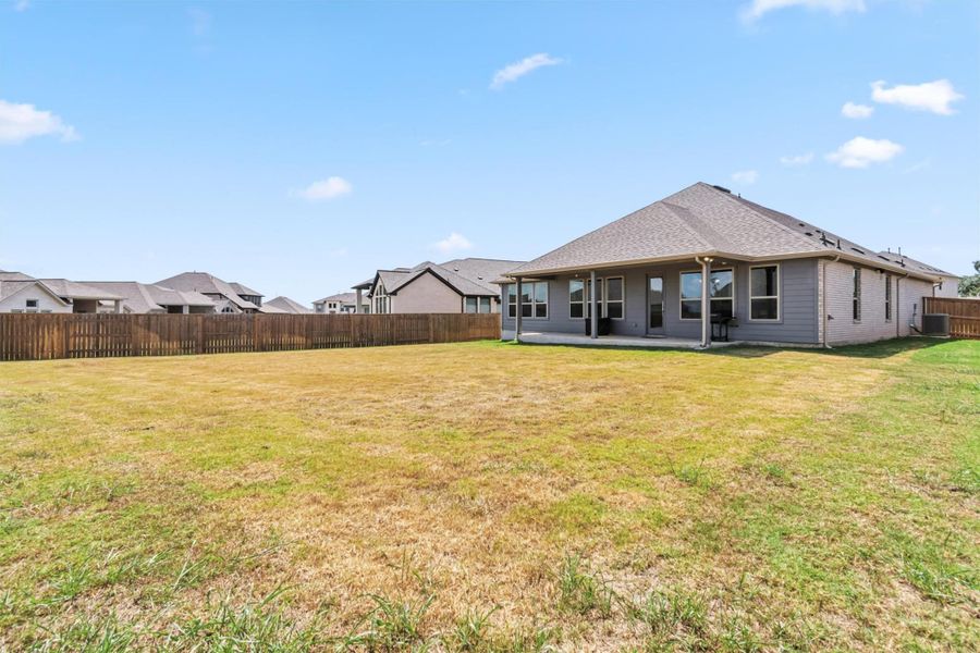 Back of property featuring a fenced backyard and a patio area Back of property featuring a fenced backyard and a patio area