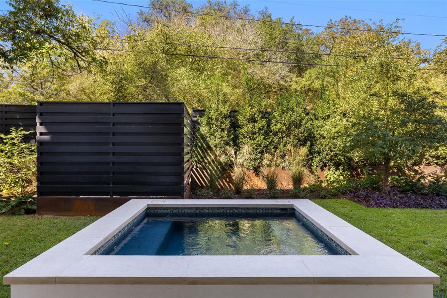 View of pool with an outdoor hot tub