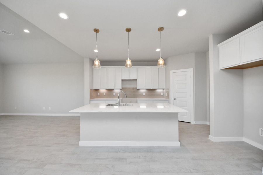 This kitchen is by far any chef’s dream! This spacious kitchen features high ceilings, light stained wood cabinets, granite countertop, SS appliances, modern tile backsplash, recessed lighting, extended counter space, granite kitchen island with double sink, and space for breakfast bar, and a walk-in pantry all overlooking your huge family room. Sample photo of completed home with similar floor plan. Actual colors and selections may vary. This kitchen is by far any chef’s dream! This spacious kitchen features high ceilings, light stained wood cabinets, granite countertop, SS appliances, modern tile backsplash, recessed lighting, extended counter space, granite kitchen island with double sink, and space for breakfast bar, and a walk-in pantry all overlooking your huge family room. Sample photo of completed home with similar floor plan. Actual colors and selections may vary.