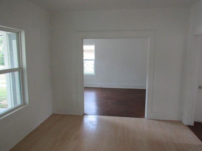 Empty room with wood finished floors and baseboards Empty room with wood finished floors and baseboards