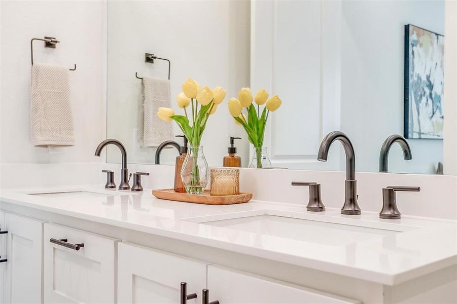 Spacious master bathroom featuring dual vanities and abundant natural light, creating a bright and luxurious retreat.