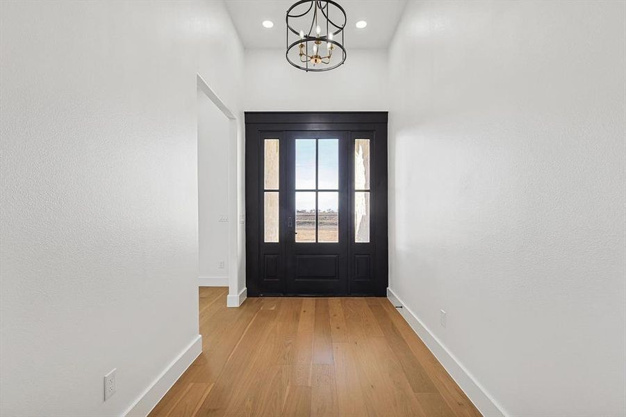 Entryway featuring a notable chandelier and light wood-type flooring