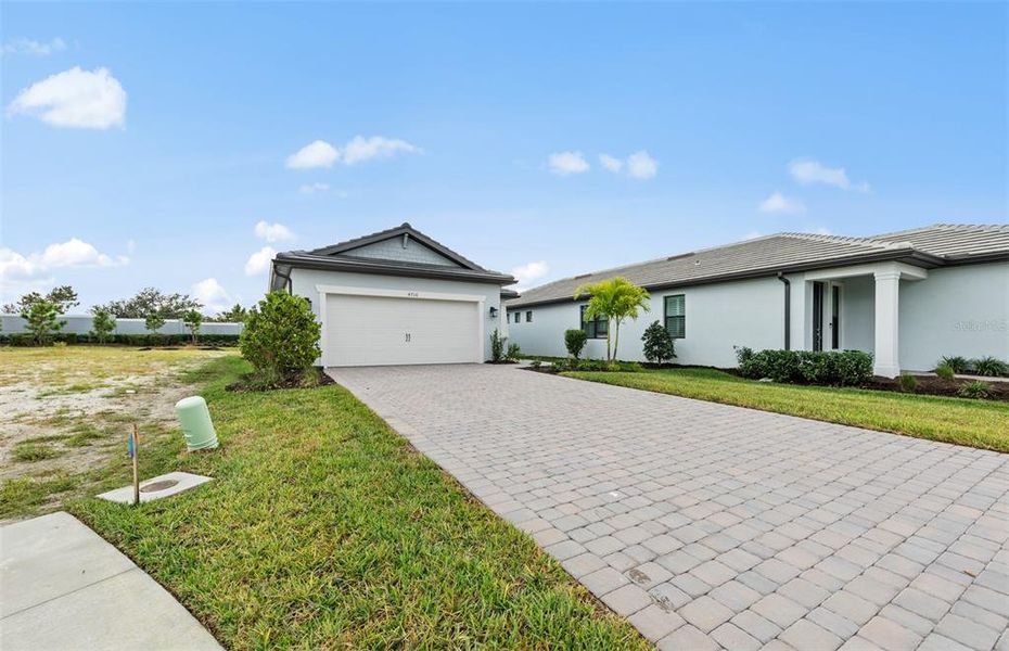 Front exterior of a new home in Arbor Oaks, North Port, FL, highlighting curb appeal (Image 1). Front exterior of a new home in Arbor Oaks, North Port, FL, highlighting curb appeal (Image 1).