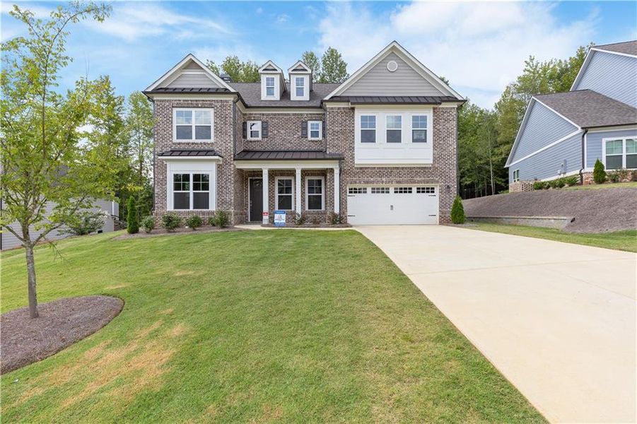Front exterior of a new home in Traditions of Braselton, Jefferson, GA, highlighting curb appeal (Image 1).