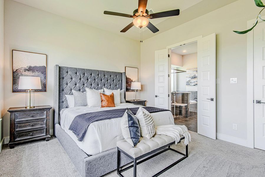 The primary bedroom leads into a luxurious en-suite bath through double doors, creating a true private sanctuary.