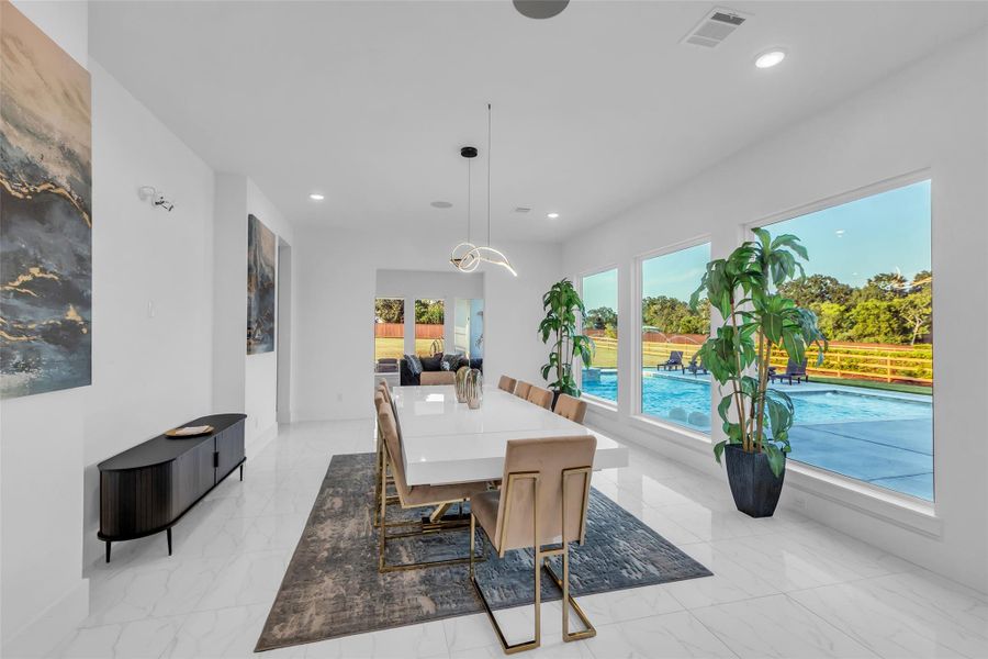 Dining Room:A statement chandelier floats above, casting light like art across a dining space framed in serene views. Designed for celebration and connection, this is where intimate dinners and grand gatherings alike are elevated by elegance.