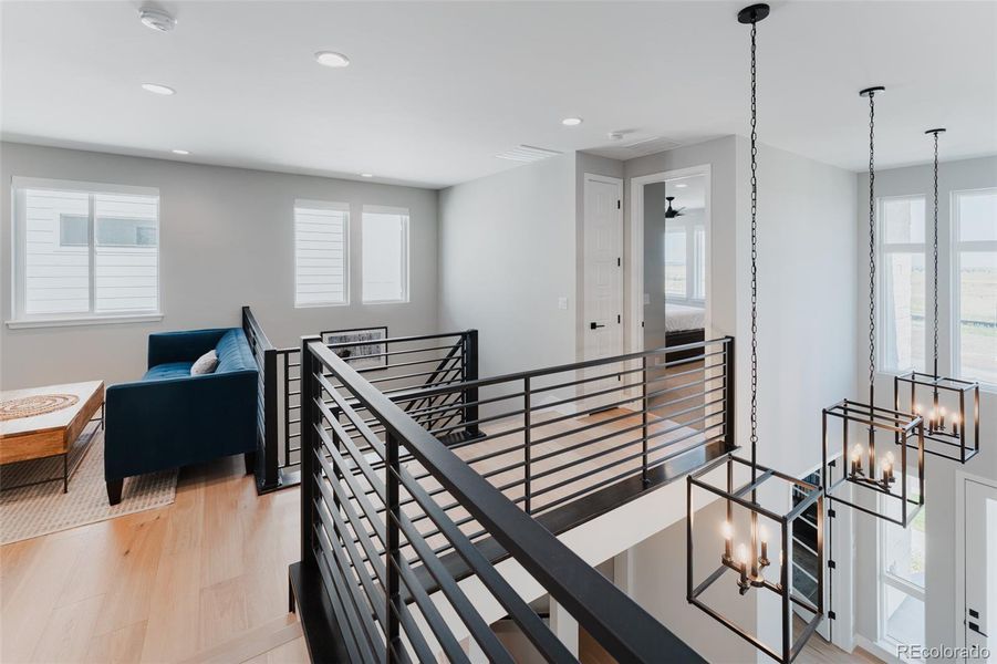 The connecting hallway overlooking the lower level enhances the sense of openness and fluidity throughout the home.