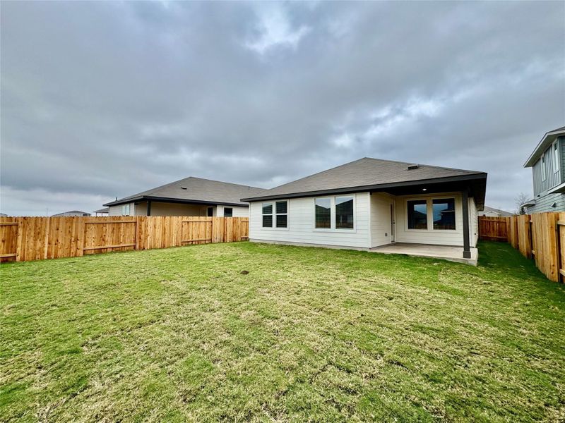 Rear view of house with a fenced backyard and a patio Rear view of house with a fenced backyard and a patio