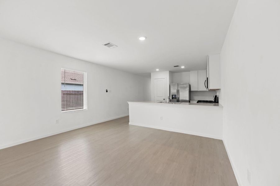Flexible dining area sits adjacent to the kitchen peninsula, with a nearby window adding natural light and plenty of open wall space for furniture placement. Flexible dining area sits adjacent to the kitchen peninsula, with a nearby window adding natural light and plenty of open wall space for furniture placement.