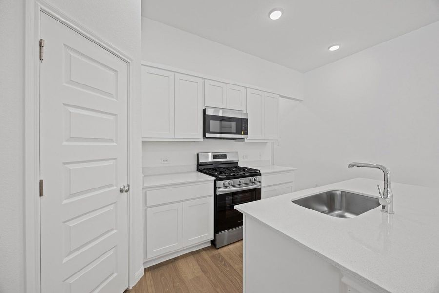 Kitchen in the Cypress home plan by Trophy Signature Homes – REPRESENTATIVE PHOTO