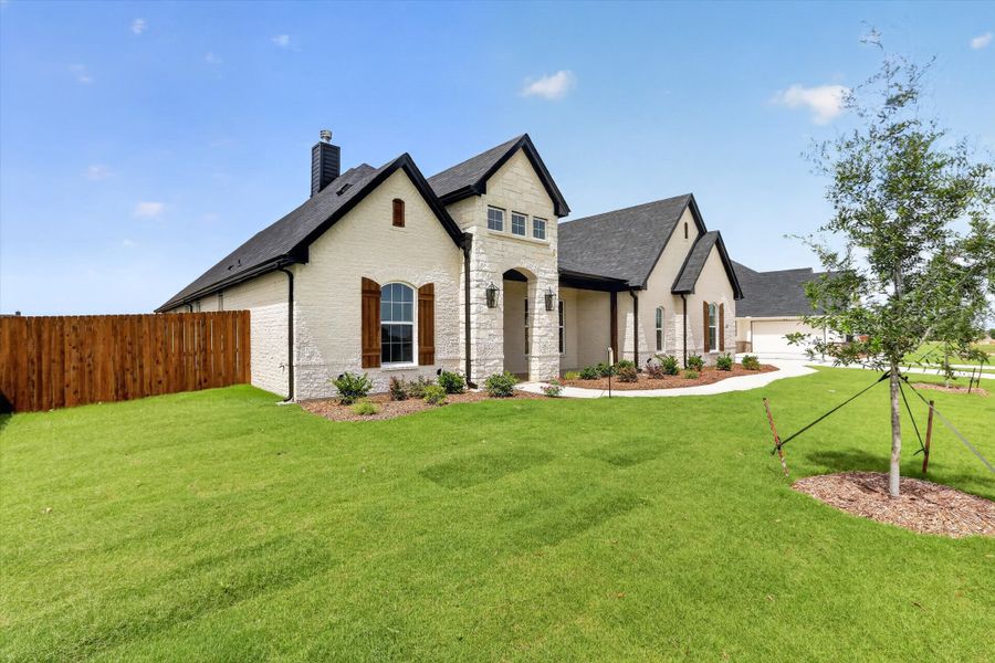 Front exterior of a new home in Coyote Crossing, Godley, TX, highlighting curb appeal (Image 21).