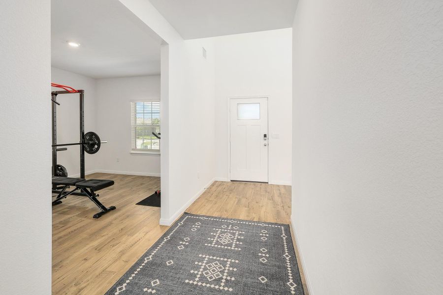 Entryway featuring wood-finish flooring, white paneled door with frosted glass insert, and recessed lighting Entryway featuring wood-finish flooring, white paneled door with frosted glass insert, and recessed lighting