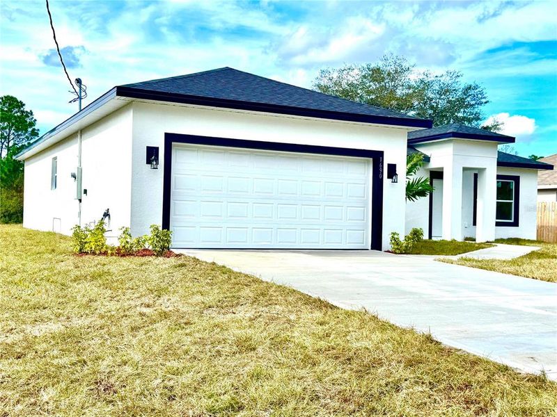 Front exterior of a new home in , Palm Bay, FL, highlighting curb appeal (Image 25).
