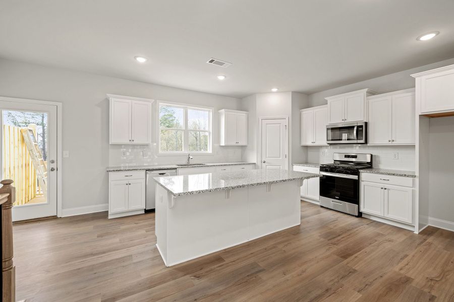 The large kitchen overlooks the dining area and family room