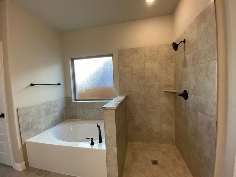 Master shower has dropped tile pan and frameless glass (not installed yet)