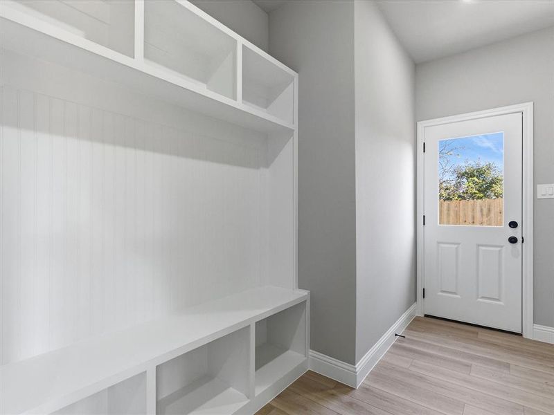 Mudroom featuring light wood-style floors and baseboards Mudroom featuring light wood-style floors and baseboards