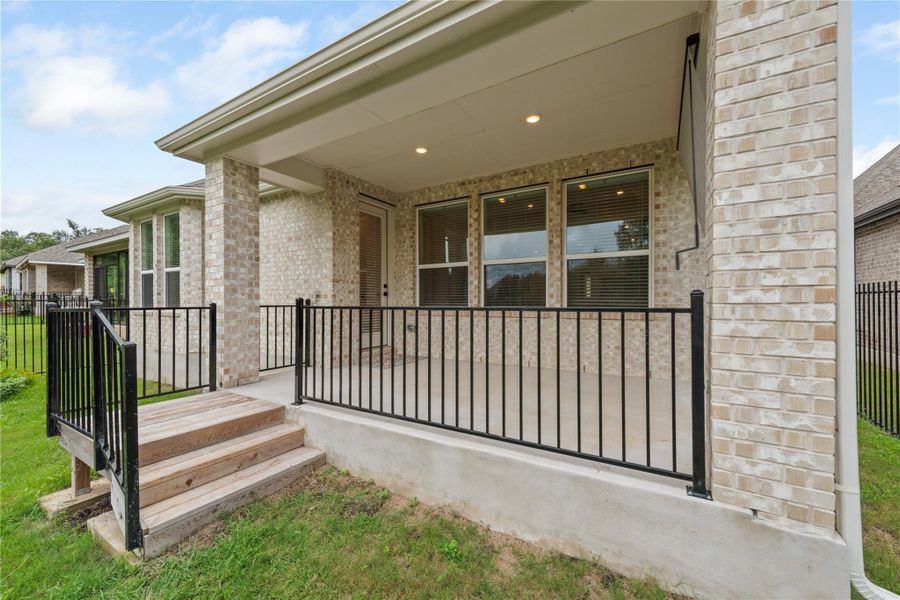 An inviting covered patio offers a relaxing outdoor retreat. An inviting covered patio offers a relaxing outdoor retreat.