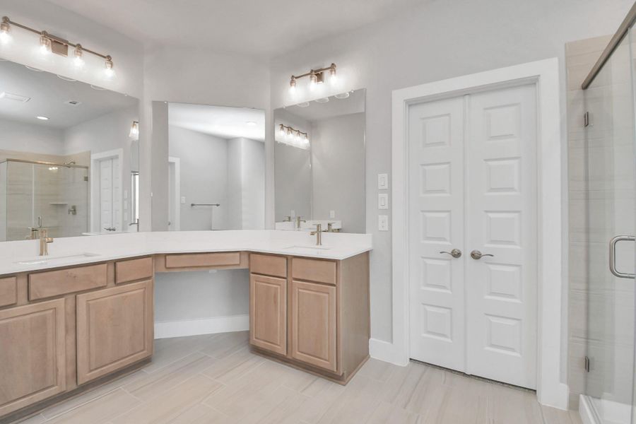 Elevate your daily routine at the elegant vanity, now equipped with double sinks, light countertops, modern hardware, and beautiful vanity lights. Elevate your daily routine at the elegant vanity, now equipped with double sinks, light countertops, modern hardware, and beautiful vanity lights.