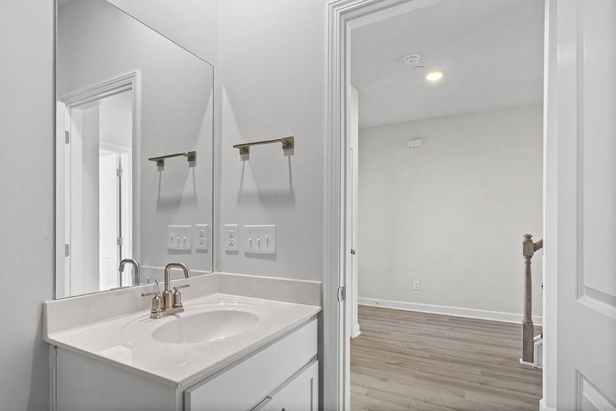 A bathroom with a large mirror. A bathroom with a large mirror.