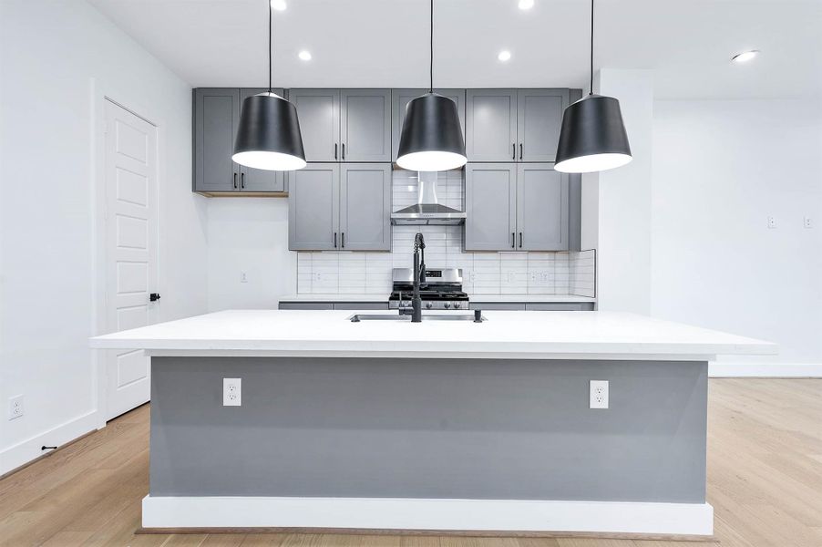 Large kitchen island with tons of counterspace and cabinet space.