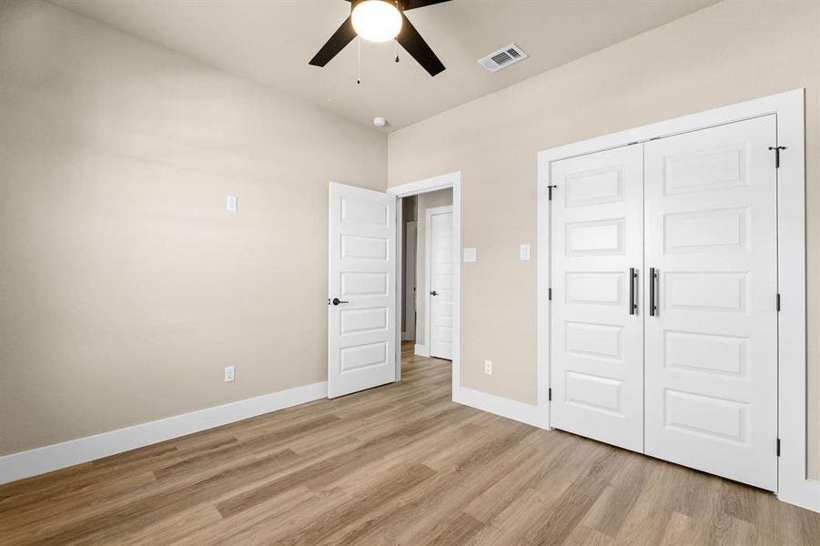 Bedroom #2 Upstairs Spacious room featuring wood-finish flooring, white baseboards, and a neutral wall color