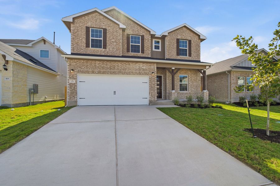 Front exterior of a new home in Sunfield, Buda, TX, highlighting curb appeal (Image 2).