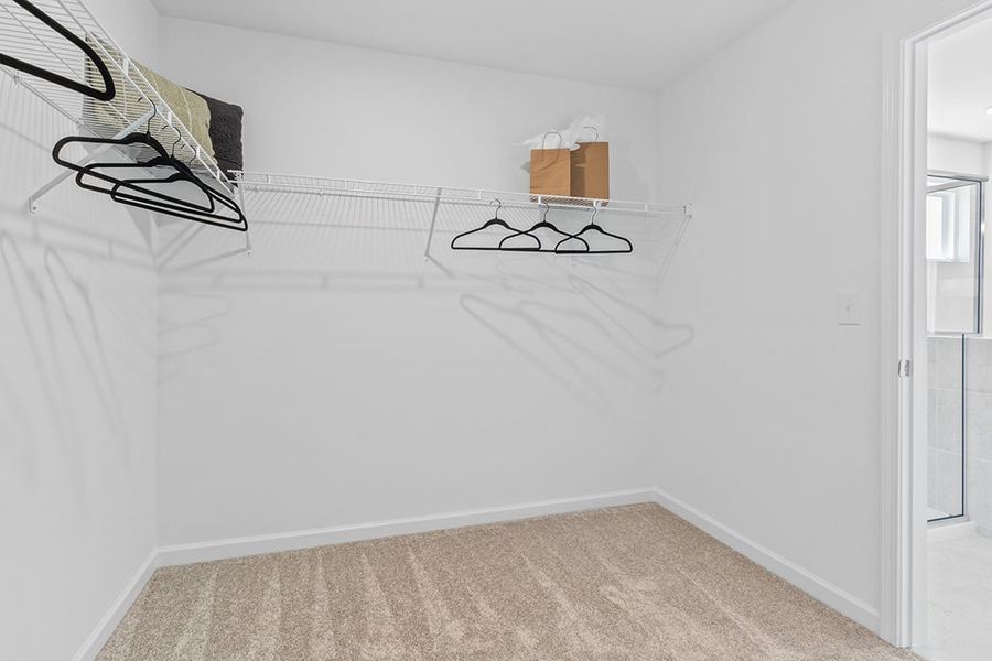 A room with a bed and a chair.