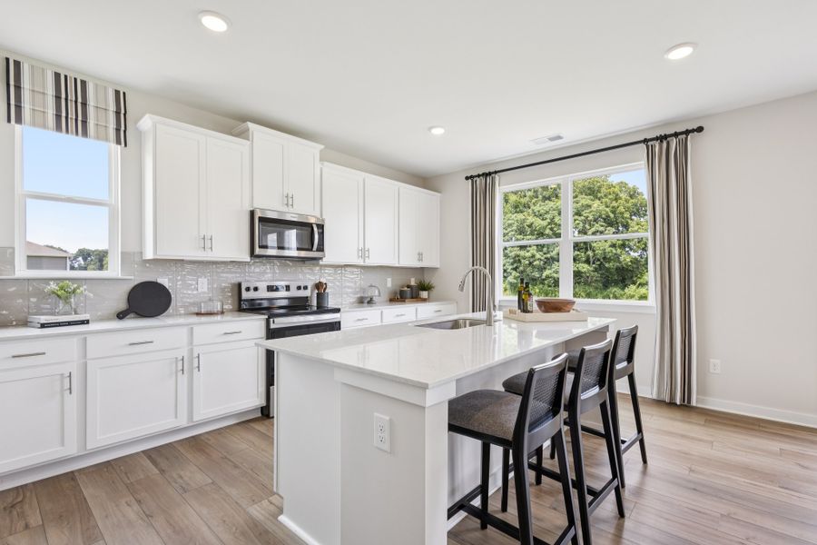 A kitchen with white cabinets. A kitchen with white cabinets.