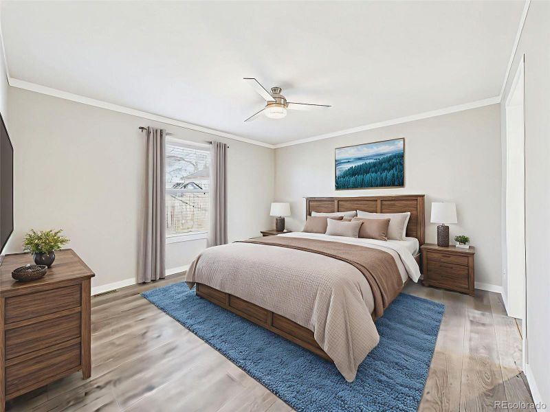 Virtually Staged Primary Bedroom – This spacious primary suite is styled with warm wood furnishings and a calming palette, showcasing room for a king-sized bed and more.