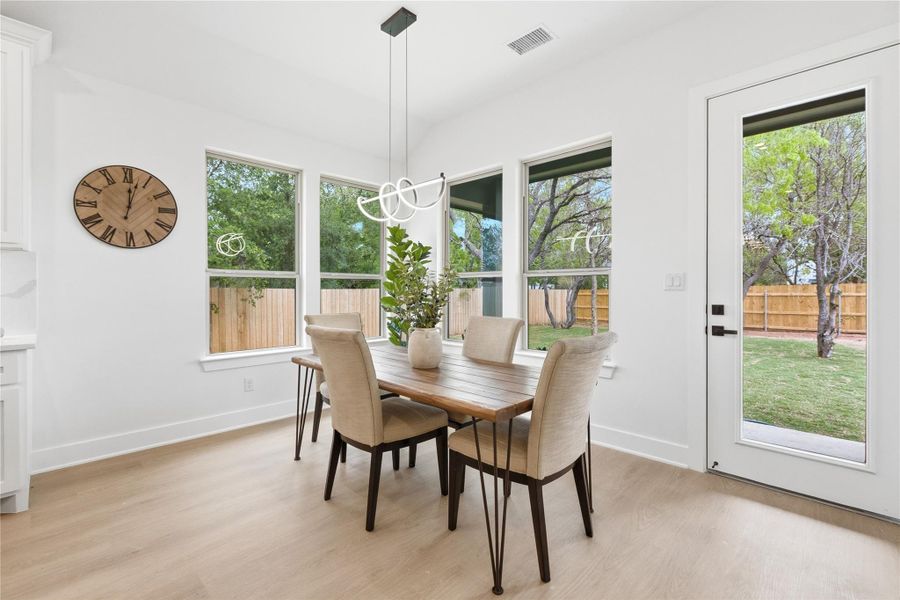 Dining area with baseboards and light wood-style floors