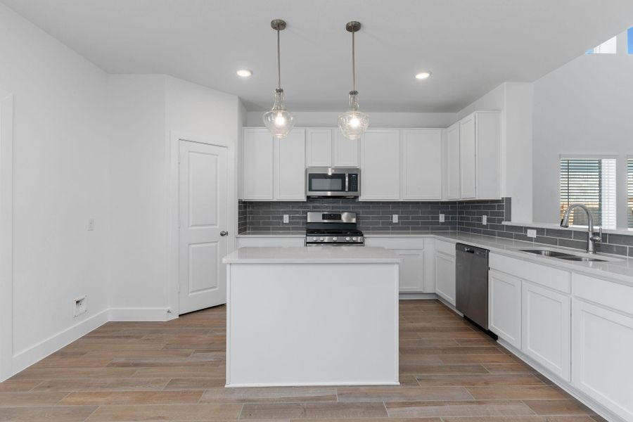 You’ll love the generous walk-in pantry that provides ample storage space, keeping everything from ingredients to appliances neatly organized. Surrounded by tall shaker cabinets, quartz counters, and stainless-steel appliances, this kitchen blends practical convenience with elegant style. You’ll love the generous walk-in pantry that provides ample storage space, keeping everything from ingredients to appliances neatly organized. Surrounded by tall shaker cabinets, quartz counters, and stainless-steel appliances, this kitchen blends practical convenience with elegant style.