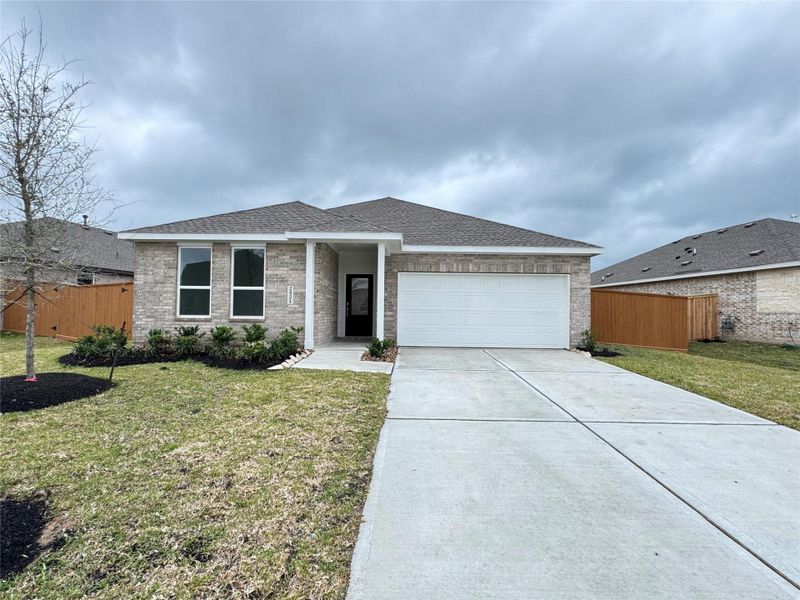Front exterior of a new home in Lago Mar: Classic Collection, Texas City, TX, highlighting curb appeal (Image 2). Front exterior of a new home in Lago Mar: Classic Collection, Texas City, TX, highlighting curb appeal (Image 2).