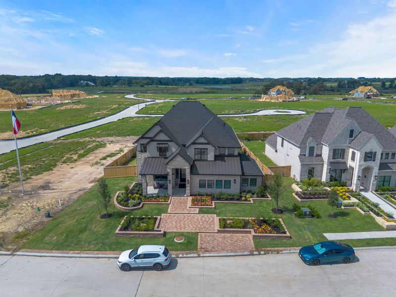 Front exterior of a new home in Evergreen, Conroe, TX, highlighting curb appeal (Image 26). Front exterior of a new home in Evergreen, Conroe, TX, highlighting curb appeal (Image 26).