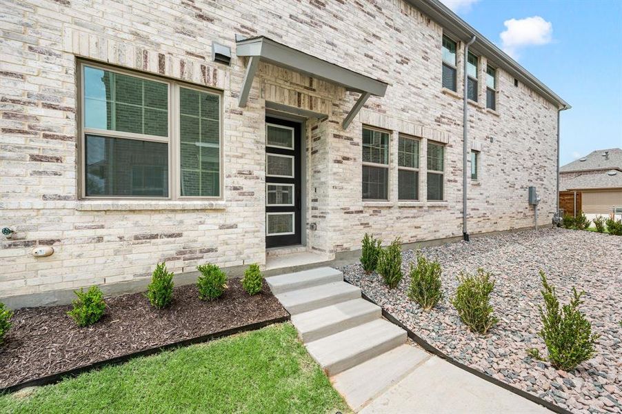 The private side entrance is the perfect place to welcome family and friends into your new dream home!