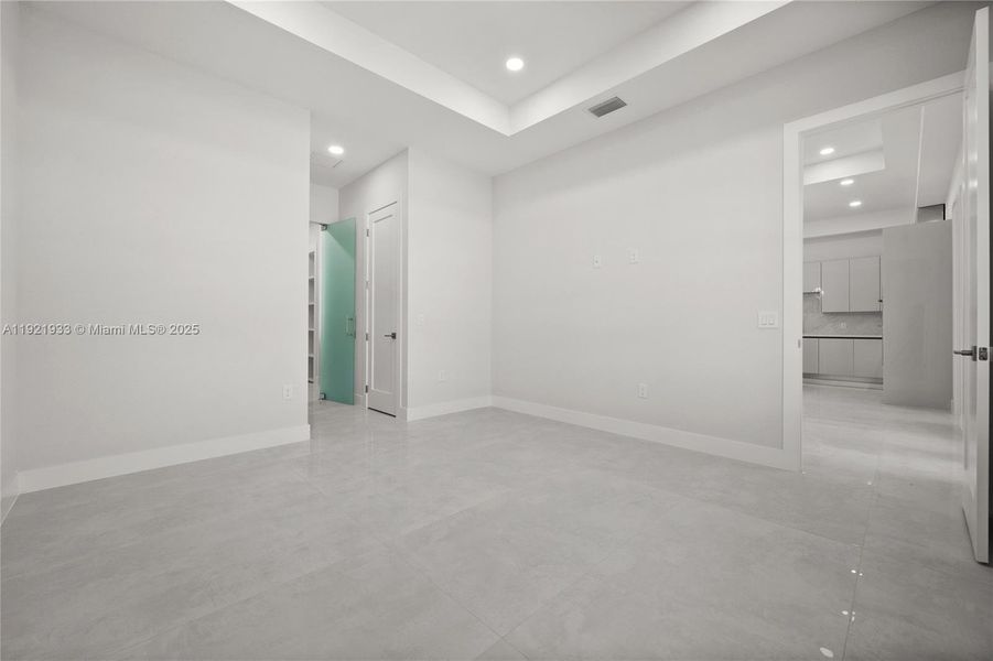 Tiled living area with a tray ceiling andrecessed lighting Tiled living area with a tray ceiling andrecessed lighting