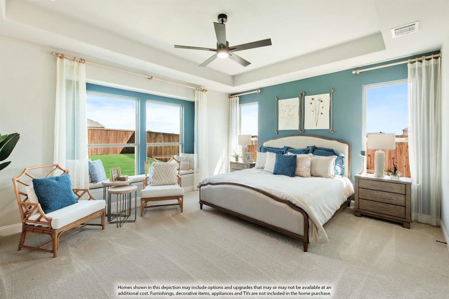 Master bedroom with tray ceiling, ceiling fan, teal accent wall, large windows, and sitting area with carpet flooring Master bedroom with tray ceiling, ceiling fan, teal accent wall, large windows, and sitting area with carpet flooring