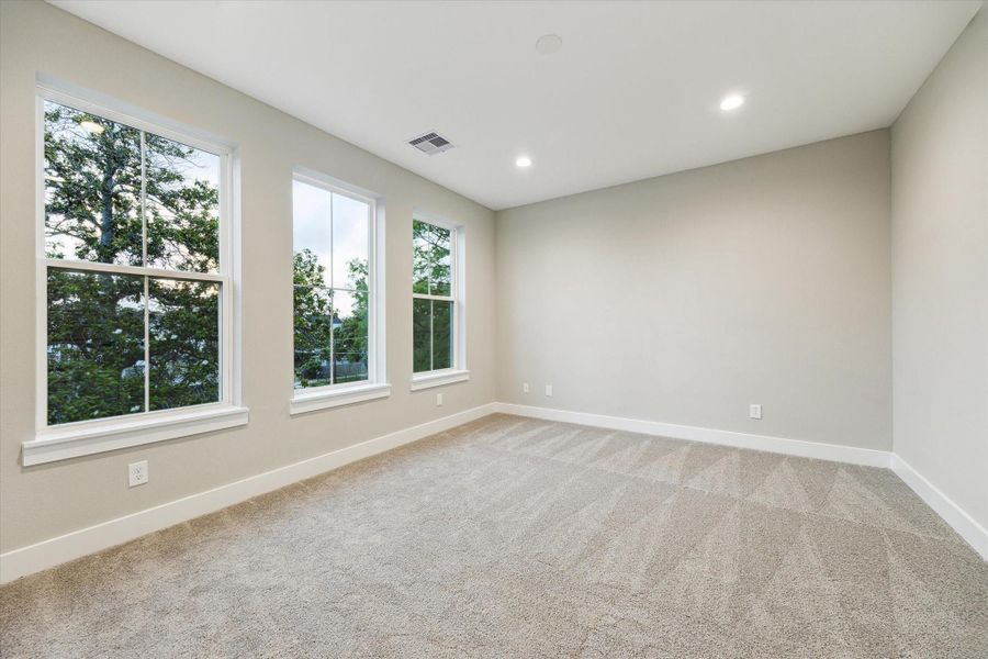 Large primary suite with a view of the tree tops