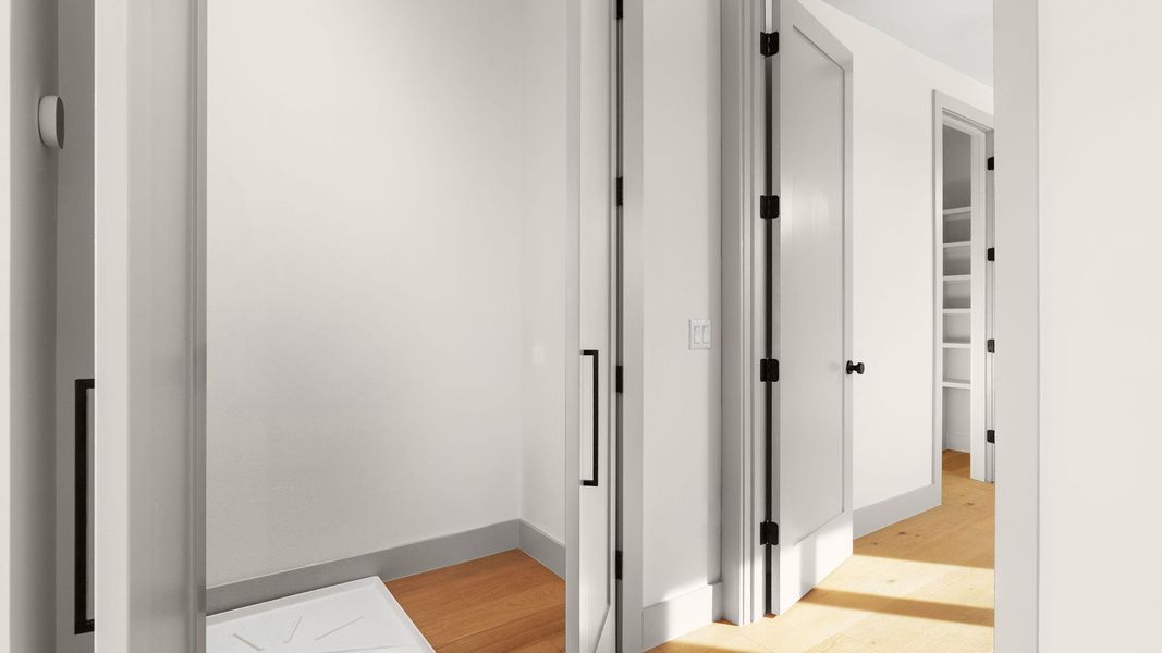 Corridor featuring light wood finished floors