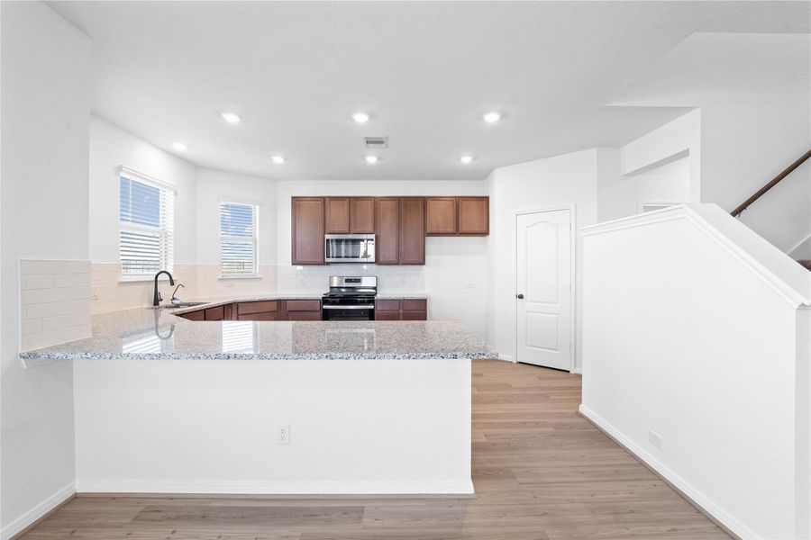 This spacious kitchen has it all—ample storage, generous counter space, and a layout that truly makes it the heart of the home.