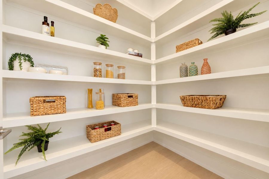 Spacious walk-in pantry featuring extensive built-in shelving with plenty of room to keep groceries, small appliances, serving pieces, and everyday essentials beautifully organized and within easy reach. Spacious walk-in pantry featuring extensive built-in shelving with plenty of room to keep groceries, small appliances, serving pieces, and everyday essentials beautifully organized and within easy reach.