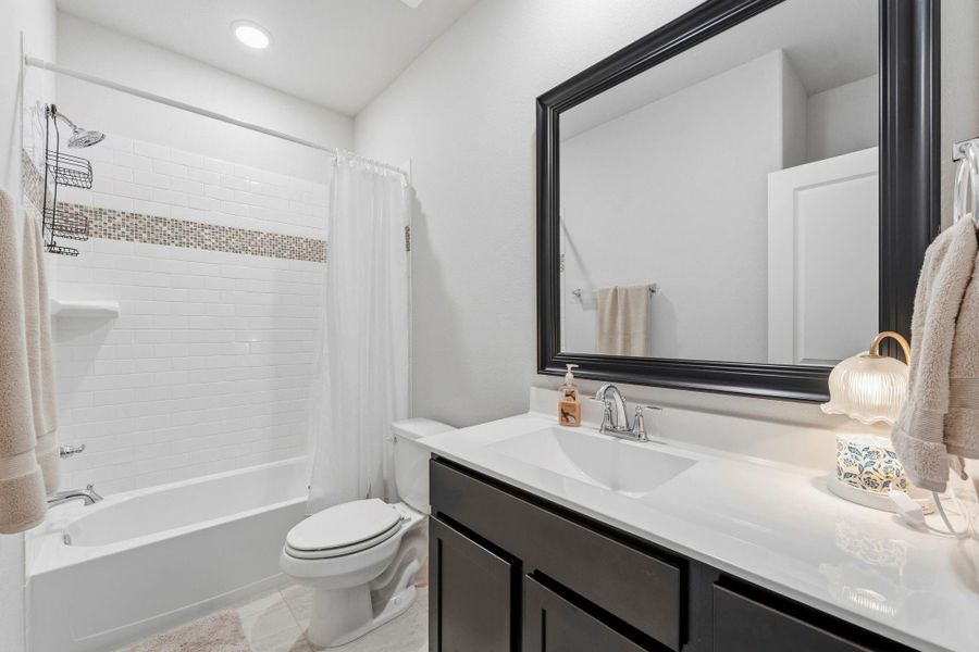 Clean lines and modern finishes make this stylish secondary bath both functional and inviting. Clean lines and modern finishes make this stylish secondary bath both functional and inviting.