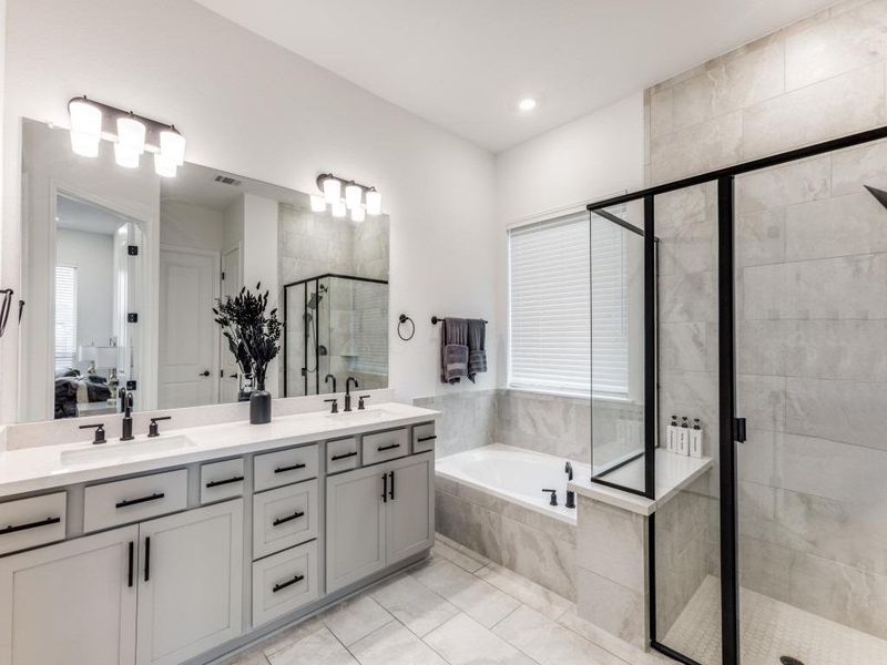 The primary's ensuite features a walk-in shower with tile surround and seperate soaking tub.