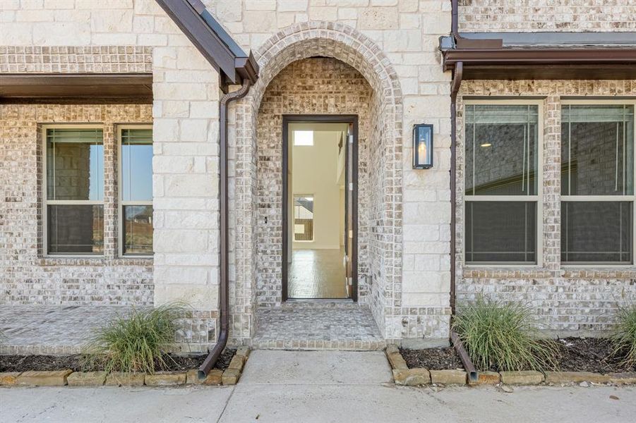 Front exterior of a new home in Wildflower Ranch 60-65, Justin, TX, highlighting curb appeal (Image 1). Front exterior of a new home in Wildflower Ranch 60-65, Justin, TX, highlighting curb appeal (Image 1).
