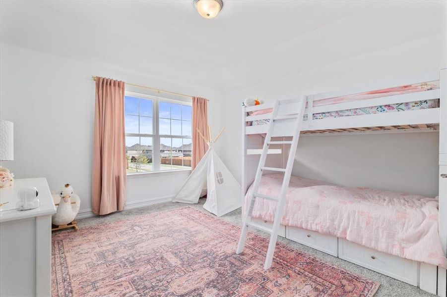 Bright room featuring carpeted flooring and white walls