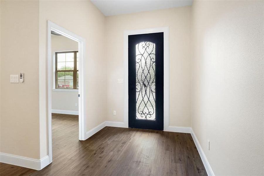 Entrance foyer featuring dark hardwood / wood-style floors