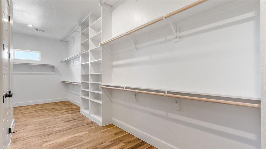 Spacious closet featuring light wood-type flooring