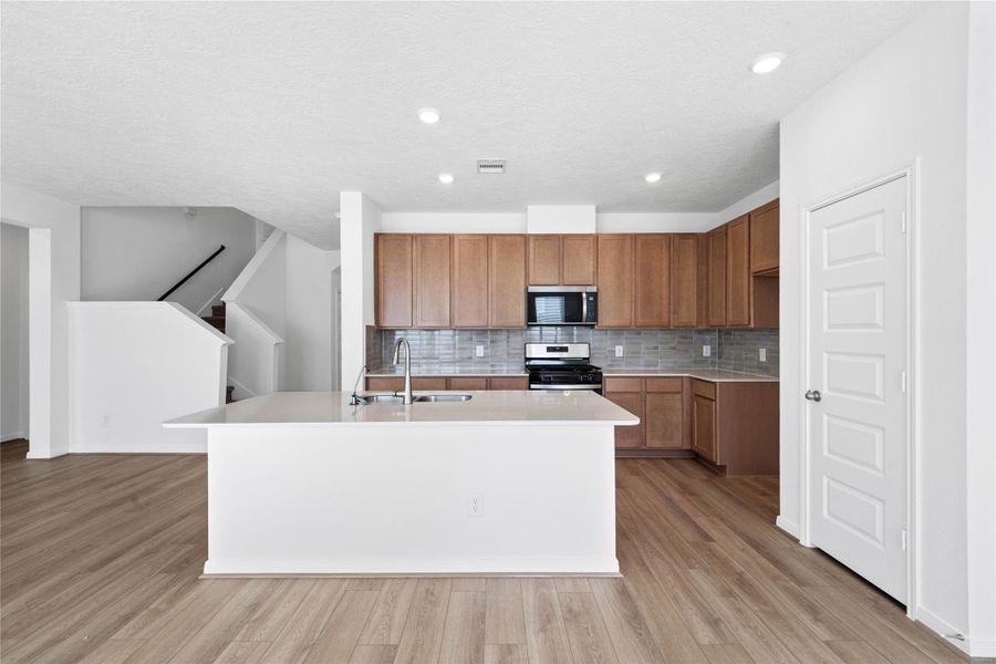 This spacious kitchen has it all—ample storage, generous counter space, and a layout that truly makes it the heart of the home.