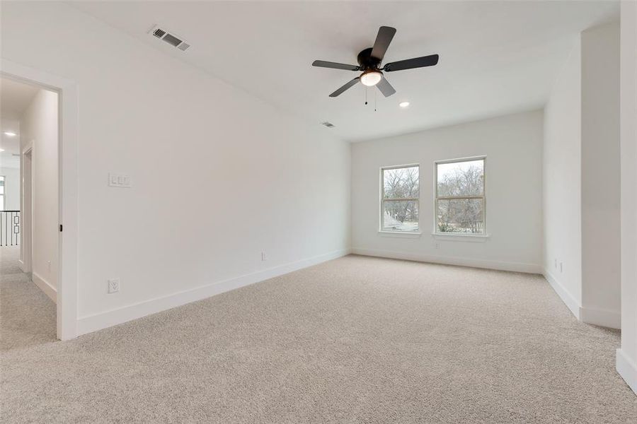 Empty room with light carpet, baseboards, visible vents, ceiling fan, and recessed lighting