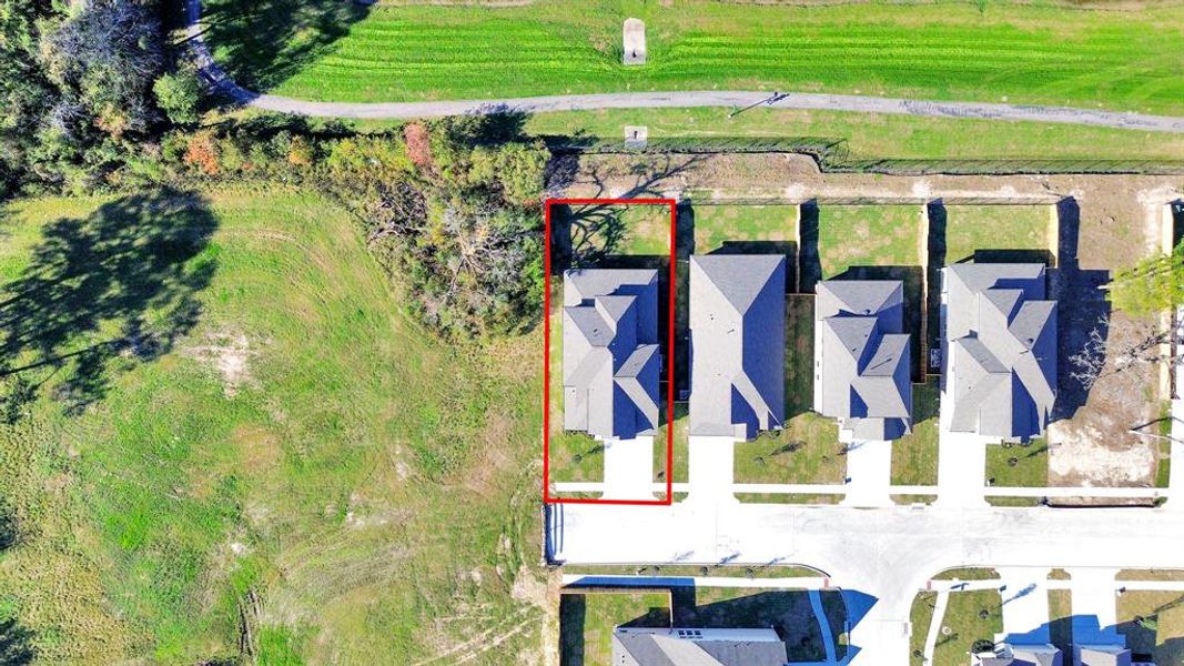 An aerial view of a spacious subdivision lot, highlighting a well-maintained yard and a fully fenced perimeter, offering both privacy andexpansive outdoor space.