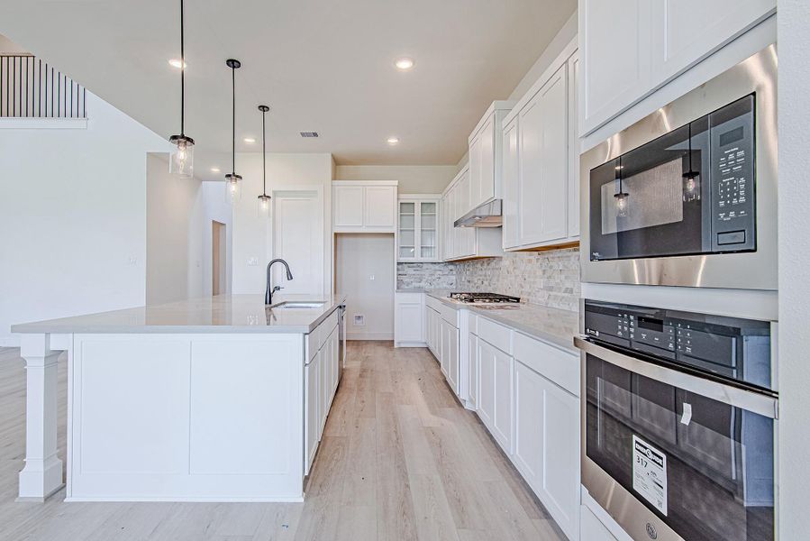 Sleek double ovens and clean-lined cabinetry bring both function and style